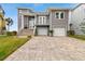 Two-story home with gray siding, double garage, and paver driveway at 5531 2Nd Avenue W Cir, Palmetto, FL 34221
