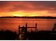 Orange sunset over calm water with a dock in the foreground at 5531 2Nd Avenue W Cir, Palmetto, FL 34221