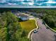Aerial view of a residential community with a house and empty lot at 7404 Mill Hopper Ct, Palmetto, FL 34221