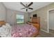 Bedroom with double bed, window, and ceiling fan at 7404 Mill Hopper Ct, Palmetto, FL 34221