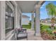 Covered front porch with seating and view of yard at 7404 Mill Hopper Ct, Palmetto, FL 34221