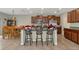 Kitchen with island, breakfast bar, and wood cabinets at 7404 Mill Hopper Ct, Palmetto, FL 34221
