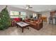 Living room with brown leather couches and Christmas tree at 7404 Mill Hopper Ct, Palmetto, FL 34221