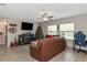 Bright living room with a Christmas tree and comfy leather couch at 7404 Mill Hopper Ct, Palmetto, FL 34221