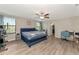 Main bedroom with large bed, hardwood floors, and ensuite bathroom at 7404 Mill Hopper Ct, Palmetto, FL 34221