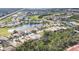 Aerial view of community with golf course and lake at 8472 Gateway Ct, Englewood, FL 34224