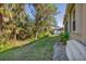 Side yard view with lush vegetation and a small boat at 8472 Gateway Ct, Englewood, FL 34224