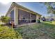 Screened patio and a partially fenced backyard with lawn at 8472 Gateway Ct, Englewood, FL 34224