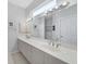 Double vanity bathroom with modern fixtures and bright lighting at 8472 Gateway Ct, Englewood, FL 34224