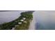 Aerial view of beachfront homes along a pristine shoreline at 8472 Gateway Ct, Englewood, FL 34224