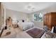 Bright bedroom with a queen-size bed and hardwood floors at 8472 Gateway Ct, Englewood, FL 34224