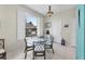 Cozy breakfast nook with a glass-top table and wicker chairs, bathed in natural light at 8472 Gateway Ct, Englewood, FL 34224
