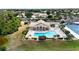 Aerial view of community pool, clubhouse, and tennis courts at 8472 Gateway Ct, Englewood, FL 34224