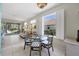 Casual dining area with glass-top table and wicker chairs at 8472 Gateway Ct, Englewood, FL 34224