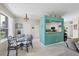 Bright dining area with glass table and four chairs, adjacent to kitchen at 8472 Gateway Ct, Englewood, FL 34224