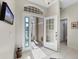 Spacious entryway with tile floors, showcasing a view of the living area and access to other rooms at 8472 Gateway Ct, Englewood, FL 34224