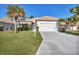 House exterior with driveway and landscaping at 8472 Gateway Ct, Englewood, FL 34224