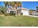 Single story home with a two car garage and lush landscaping at 8472 Gateway Ct, Englewood, FL 34224