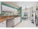 Kitchen with stainless steel dishwasher and view into dining area at 8472 Gateway Ct, Englewood, FL 34224