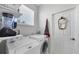 Bright laundry room with washer, dryer and extra shelving at 8472 Gateway Ct, Englewood, FL 34224