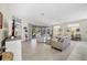 Bright and airy living room with tile floors, neutral decor, and ample natural light at 8472 Gateway Ct, Englewood, FL 34224