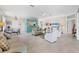 Open living room with neutral decor and access to dining and kitchen areas at 8472 Gateway Ct, Englewood, FL 34224