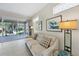 Living room with beige sofa and sliding doors leading to patio at 8472 Gateway Ct, Englewood, FL 34224