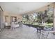 Relaxing screened porch with wicker furniture and view of backyard at 8472 Gateway Ct, Englewood, FL 34224