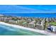 Aerial view of a waterfront condo building with a beautiful beach and water at 1065 Gulf Of Mexico Dr # 201, Longboat Key, FL 34228