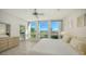 Main bedroom with large windows, offering a view of the golf course and water at 1065 Gulf Of Mexico Dr # 201, Longboat Key, FL 34228
