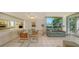 Dining area with glass table and chairs, open to the kitchen at 1065 Gulf Of Mexico Dr # 201, Longboat Key, FL 34228
