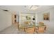 Condo dining room with a glass table and chairs near the kitchen at 1065 Gulf Of Mexico Dr # 201, Longboat Key, FL 34228