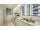 Condo kitchen featuring white cabinets, stainless steel sink, and appliances at 1065 Gulf Of Mexico Dr # 201, Longboat Key, FL 34228