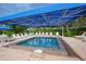 Relaxing pool area with shaded seating and lounge chairs at 1065 Gulf Of Mexico Dr # 201, Longboat Key, FL 34228