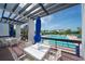 Patio area with tables and pool view at 1065 Gulf Of Mexico Dr # 201, Longboat Key, FL 34228