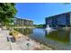 Beautiful waterfront view with a relaxing bench at 1065 Gulf Of Mexico Dr # 201, Longboat Key, FL 34228