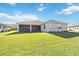 Home's backyard showcasing a large grassy area at 11907 Petunia Ter, Bradenton, FL 34212