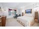 Spacious Primary bedroom with a king-size bed and relaxing sitting area at 11907 Petunia Ter, Bradenton, FL 34212