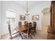 Bright dining room with wood table and chairs, chandelier, and decorative accents at 11907 Petunia Ter, Bradenton, FL 34212