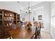 Spacious dining area showcasing a wood table, cabinetry, and a chandelier at 11907 Petunia Ter, Bradenton, FL 34212