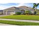 Beautiful one-story home with three-car garage, lush lawn, and mature landscaping at 11907 Petunia Ter, Bradenton, FL 34212
