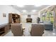 Relaxing Gathering room with two armchairs, a couch, and views to backyard at 11907 Petunia Ter, Bradenton, FL 34212