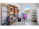 Home office with built-in bookshelves, desk, and a view of a pond at 11907 Petunia Ter, Bradenton, FL 34212