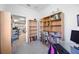 Home office with built-in shelving, desk, and view to kitchen at 11907 Petunia Ter, Bradenton, FL 34212