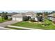House exterior featuring a three car garage and manicured lawn at 11907 Petunia Ter, Bradenton, FL 34212