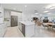 Open kitchen with island, stainless steel appliances, and views into Gathering room at 11907 Petunia Ter, Bradenton, FL 34212