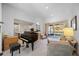 Living room features a grand piano, comfy seating, and views of the backyard at 11907 Petunia Ter, Bradenton, FL 34212
