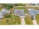 House with gray roof, attached garage, and large backyard at 161 Sandhurst Dr, Venice, FL 34293