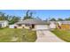 One-story house with a white garage door and green lawn at 161 Sandhurst Dr, Venice, FL 34293