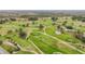 Aerial view of a lush green golf course at 161 Sandhurst Dr, Venice, FL 34293